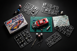 AMT Racing scale model kits including classic NASCAR stock cars, drag racers, and muscle car builds displayed in 1/25 scale for hobbyists and scale modelers.