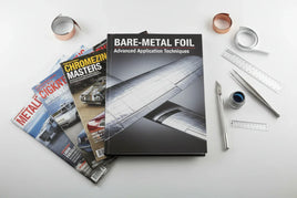 Bare-metal foil books, magazines, rulers, tweezers, and hobby tools on white background