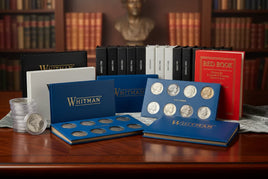 Coin collecting supplies with Whitman holders, U.S. coin folders, and guidebooks on display.