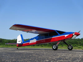Red, blue, and white Javelin RC aircraft model on runway under clear blue sky
