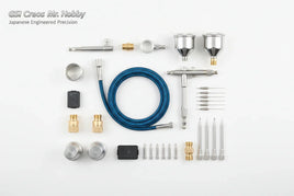 GSI Creos Mr. Hobby airbrush accessories kit including nozzles, needles, cups, hose, and fittings, arranged on a white background for MPM Hobbies.