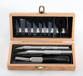 Wooden box set with hobby knives, carving blades, and precision cutting tools on white background