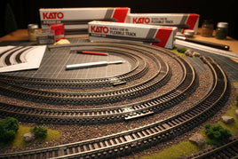 N scale model train tracks setup with Kato flexible track boxes on a hobby workbench at MPM Hobbies