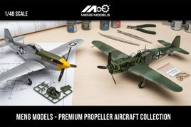 Meng Models 1/48 scale propeller aircraft model kits on a workbench with tools and paints, featured by MPM Hobbies.