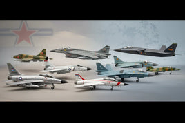 Scale model fighter jets in various paint schemes displayed on a gray surface at MPM Hobbies.