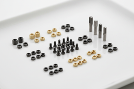 Assorted gold and black nuts, screws, and standoffs for model building on white tray, MPM Hobbies