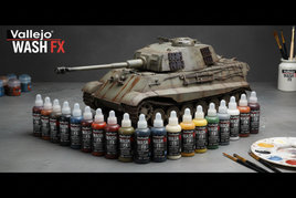 Vallejo Wash FX paints displayed in front of a model tank, with brushes for scale modeling.