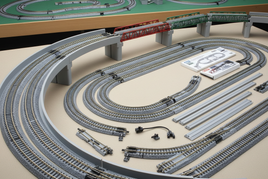 Model train tracks and bridges setup with accessories and manuals, MPM Hobbies railroad layout kit