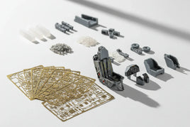 Assorted 3D printed model airplane cockpit parts and photo-etched metal sheets from MPM Hobbies