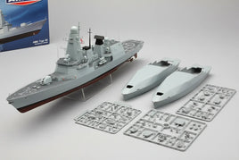 Plastic model kit of HMS Type 45 warship with assembled ship, sprue parts, and hull pieces from MPM Hobbies.