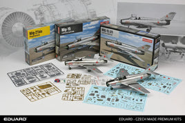 Eduard MiG-21bis and MiG-15 model kits with plastic sprues, decals, and finished aircraft models