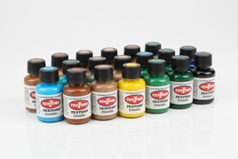 Testors enamel paint bottles in fluorescent blue, brown, desert tan, yellow, green, and black finishes displayed on white background, classic 1/4 oz glass bottles with Testors labels