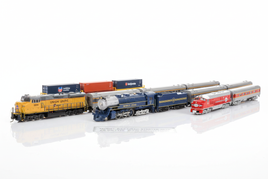N scale model train sets including locomotives and passenger cars showing detailed paint schemes on white surface for ready-to-run model railroad starter sets and complete train collections