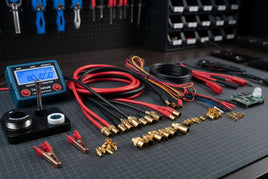 Electronics workbench with multimeter, wires, connectors, and soldering tools from MPM Hobbies