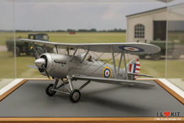 1/48 scale biplane model kit with RAF roundels displayed on a wooden stand at MPM Hobbies