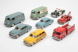 Assorted vintage model cars and trucks, including police, taxi, tow, and fire vehicles, on white background.