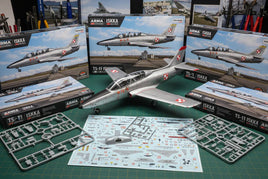 ARMA Hobby TS-11 Iskra model kit with unassembled parts, decals, and finished aircraft on workbench at MPM Hobbies