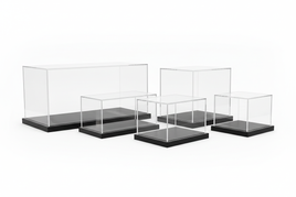 Assorted clear acrylic display cases with black bases for models or collectibles at MPM Hobbies