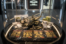 Model helicopter kit with 3D printed accessories, detailing parts, and hobby supplies on display at MPM Hobbies.