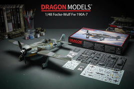 Dragon Models 1/48 Focke-Wulf Fw 190A-7 plastic model kit with parts, decals, and assembly tools on a hobby workspace.