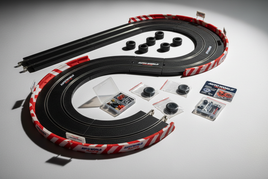 Auto World slot car racing track kit with tires, spare parts, and accessories displayed on table