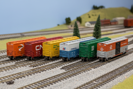 N scale boxcars featuring Atlas 50-foot freight cars in BNSF Canadian National Chicago North Western Conrail and Montana Rail Link liveries on track