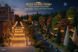 Model railroad night scene with illuminated street lights, trees, buildings, and a train for MPM Hobbies.