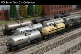 HO scale model tank cars on train tracks with detailed background scenery
