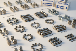 Organized display of DU-BRO RC aircraft nuts and bolts including hex nuts, blind nuts, nylon lock nuts, and wing bolts in standard and metric sizes on white background