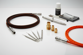 Sparmax airbrush accessories including precision needles, nozzles, braided hoses, and cleaning tools for professional airbrushing