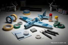 Scale model airplane with masking tape, paint markers, and hobby tools on workbench, MPM Hobbies