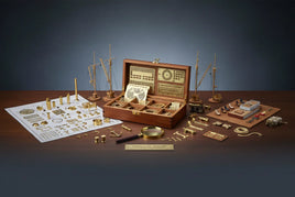 Wooden box with model ship parts, brass fittings, tools, and instructions on a table, MPM Hobbies