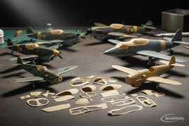 Scale model airplanes and 3D printed parts on hobby workspace, MPM Hobbies model kits