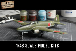 1/48 scale Japanese Imperial Navy jet aircraft model kit with paints and tools on hobby mat