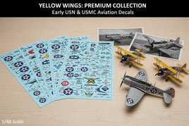 Yellow Wings Premium Collection early USN USMC aviation decal sheets with scale model airplanes and vintage aircraft photos on a wood surface.