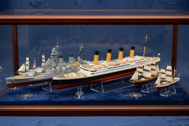 Display case with detailed mid-scale naval model ships on blue velvet, MPM Hobbies collection.