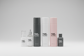 Tamiya Fine Surface Primer L aerosol spray cans in grey, white, light grey, and pink, plus liquid primer bottles with brush applicators for scale model preparation