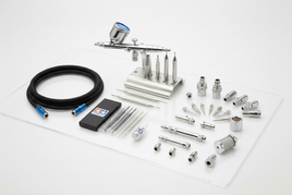 Tamiya Spray-Work airbrush accessories set with hose, nozzles, connectors, and tools on white background