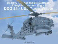 Model helicopter with text about US Navy ship USS Curtis Wilbur against a blue sky.