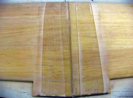 Close-up of a wooden cutting board with a natural finish