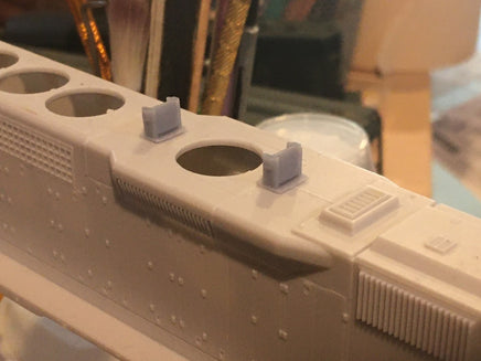 Close-up of a 3D-printed model of a spaceship or vehicle with a blurred background.