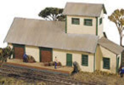 Model train station with people and cargo on a white background