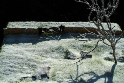 Frosty landscape with a wooden bench and bare tree