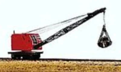 Model of a crane on a track with a red body and black crane arm.