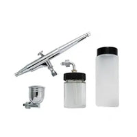 Airbrush set with multiple components on a white background
