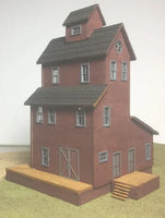 Model of a two-story red brick building with a clock tower on a white background