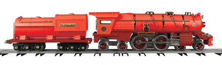 Red toy steam locomotive on tracks with a white background