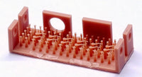 Pink plastic mold with small figurines on a white background