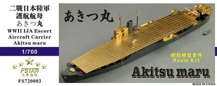 Model of WWII IJA Escort Aircraft Carrier Akitsu Maru with gold deck, on a gray background.