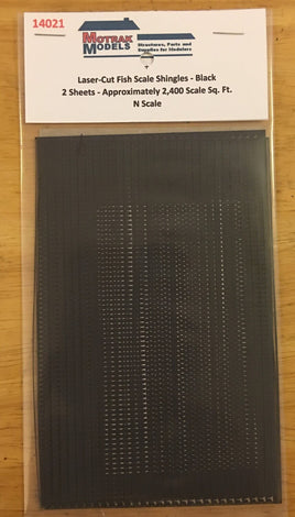 Packaged black fish scale shingles for model building on a wooden surface